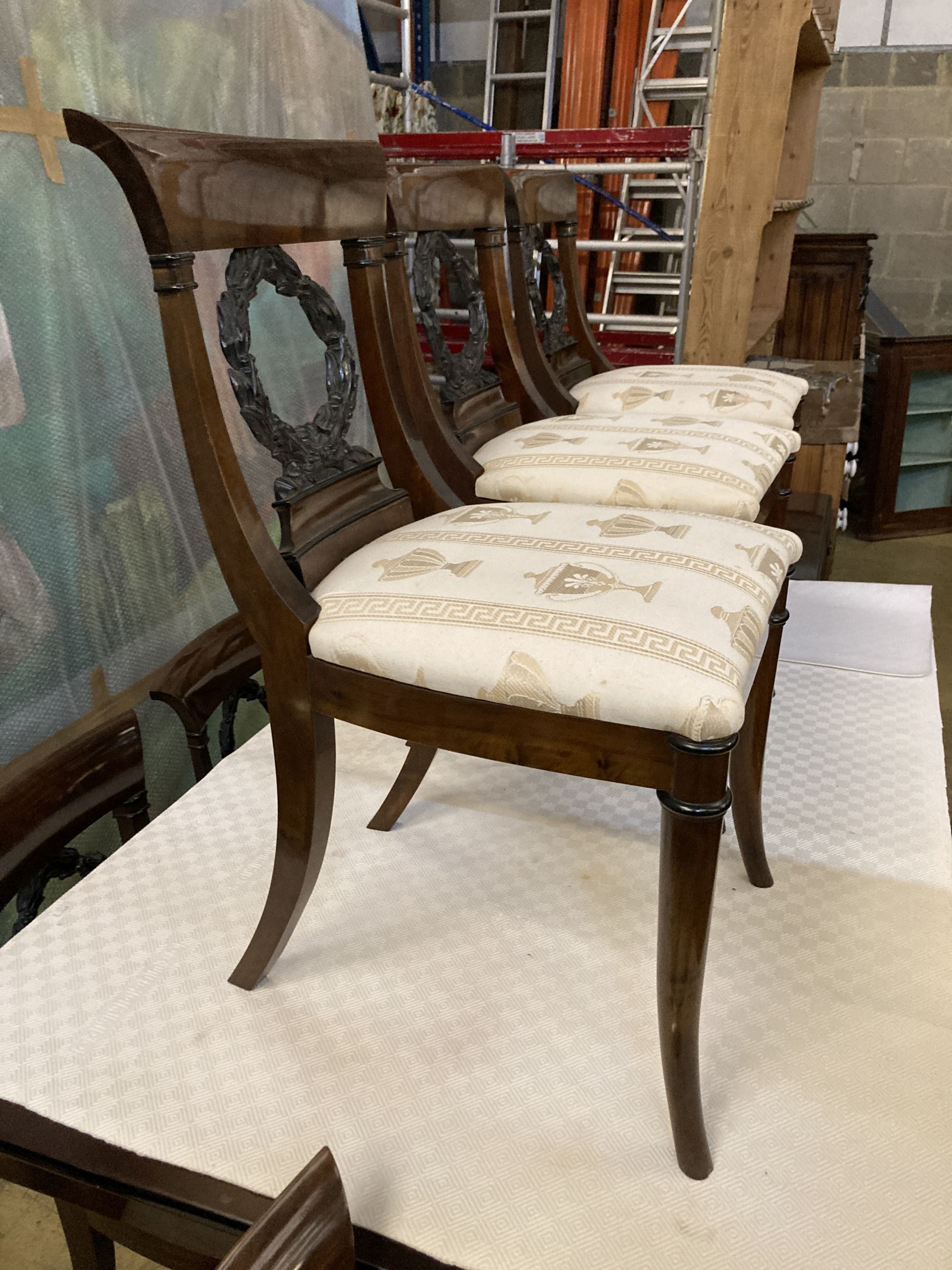 A Regency style mahogany dining suite, comprising rectangular dining table, 176cm extended (one spare leaf), six chairs and a side cabi